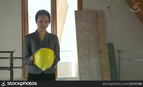 Jobs, young people at work, professions, workers. Asian business woman, businesswoman, industry worker, girl, portrait of happy engineer, architect smiling in construction site, new building. 1 of 15