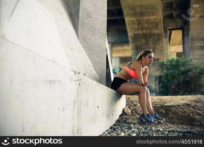 Jogger taking break on bridge, Arroyo Seco Park, Pasadena, California, USA