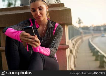 Jogger using cellular phone on bridge, Arroyo Seco Park, Pasadena, California, USA