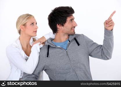 Joggers looking at an aeroplane in the sky