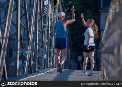 jogging friends couple congratulate and happy to finish their morning workout