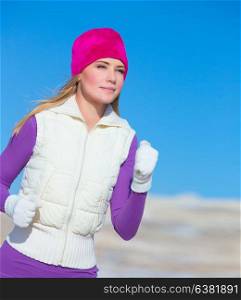 Jogging outdoors, portrait of cute sportswoman running outside, workout in winter time, sportive achievement, active lifestyle concept
