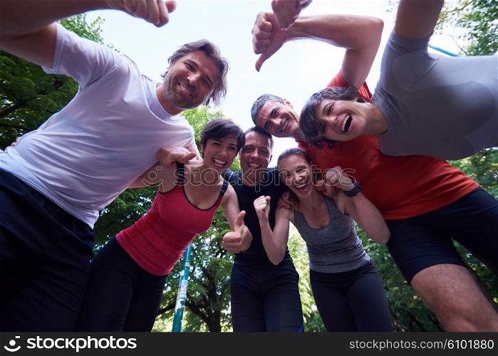 jogging people group, friends have fun, hug and stack hands together after training