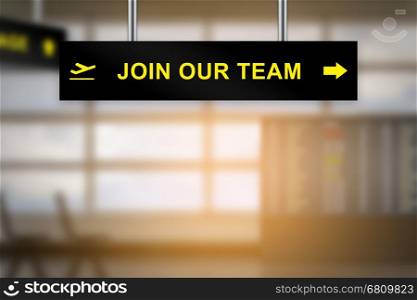 join our team on airport sign board with blurred background and copy space