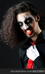 Joker personification with man in dark room