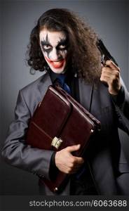 Joker with gun and briefcase