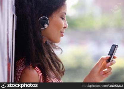 Jolly young woman in headphones listen to music