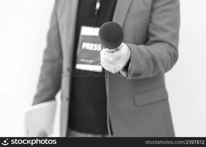 Journalist holding microphone making media interview. Journalism concept.