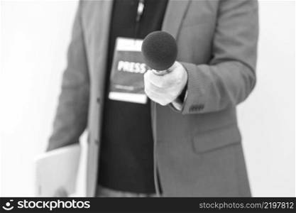 Journalist holding microphone making media interview. Journalism concept.