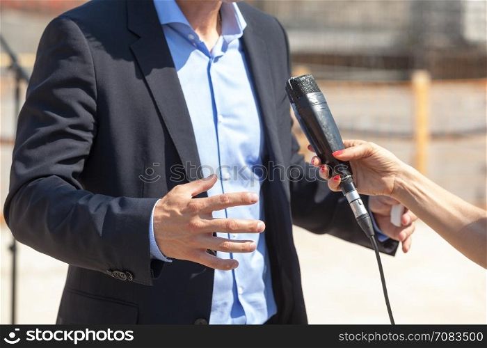 Journalist making interview with businessman or politician