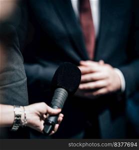 Journalists holding microphone, interviewing politician.. Journalist Conducting an Interview, Politician Answering Questions.