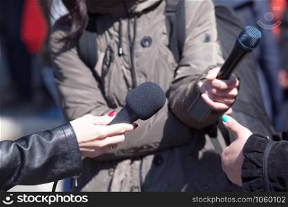 Journalists holding microphones at news conference