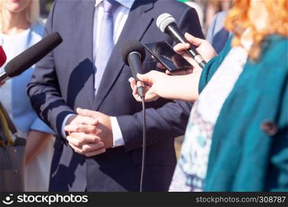Journalists making media interview with business person or politician