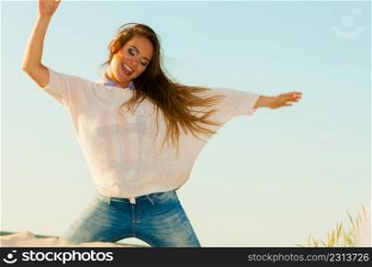Joy and carefree. Gorgeous long haired woman having fun on beach. Young joyful attractive girl feels freedom. Summer time.. Young joyful girl on beach.