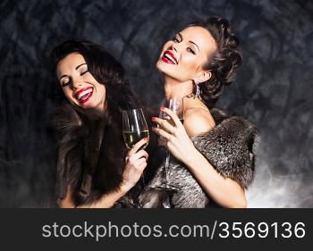 Joy. Elation. Rich woman laughing with crystal of champagne