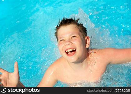 joyful boy in pool. Jump in water