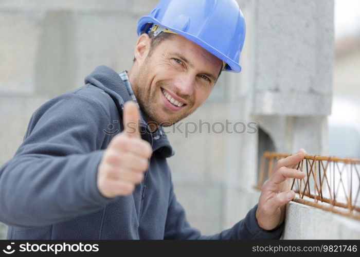 joyful builder shows thumbs up