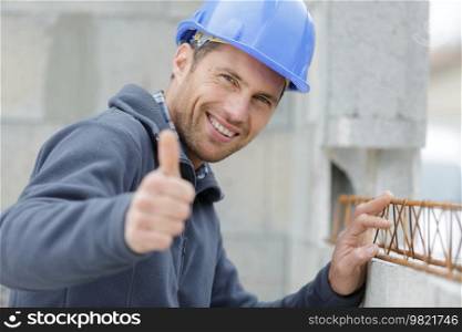 joyful builder shows thumbs up
