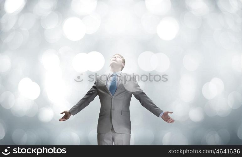 Joyful businessman with outstretched arms celebrating success