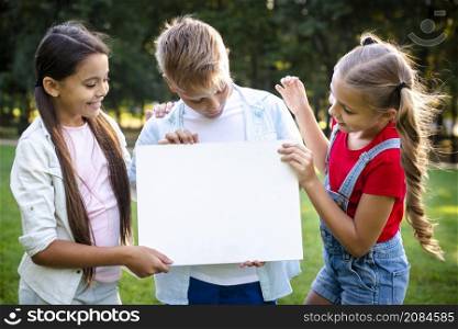joyful children holding blank paper