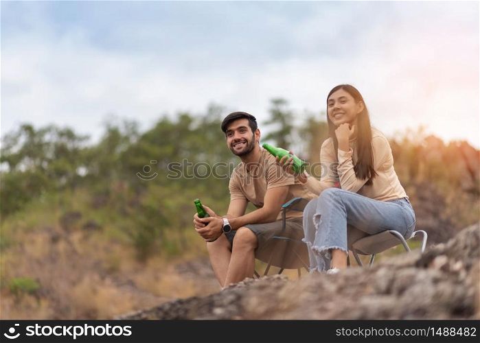 Joyful Couple camping on the mountains. Holiday maker, Relaxing, Multi-ethnic, Copy space.