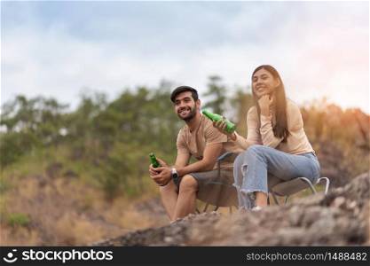 Joyful Couple camping on the mountains. Holiday maker, Relaxing, Multi-ethnic, Copy space.