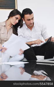 joyful couple relax and work on laptop computer at modern living room indoor home