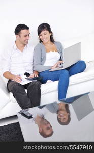 joyful couple relax and work on laptop computer at modern living room indoor home