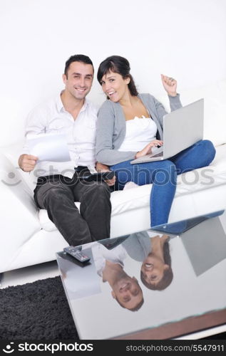 joyful couple relax and work on laptop computer at modern living room indoor home