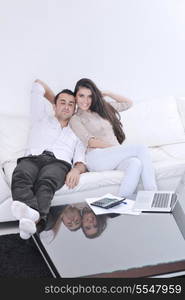 joyful couple relax and work on laptop computer at modern living room indoor home