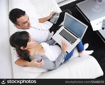 joyful couple relax and work on laptop computer at modern living room indoor home