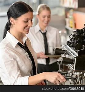 Joyful female barista operating coffee maker machine in coffee shop