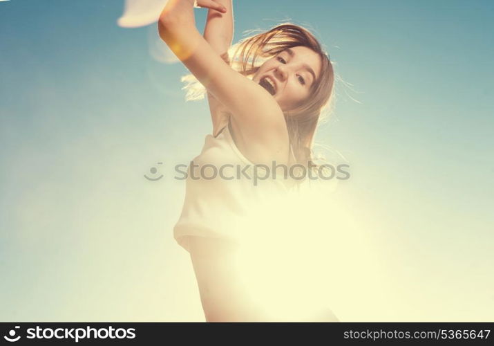 Joyful female jumping with the blue sky in the background