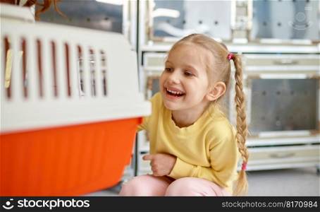 Joyful girl child feeling happy after buying cat at shop. Girl with cat carrier. Cheerful new pet owners. Joyful girl child feeling happy after buying cat at shop