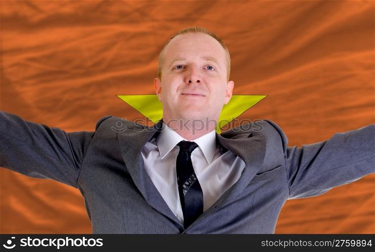 joyful investor spreading arms after good business investment in vietnam, in front of flag