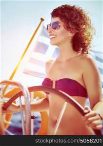 Joyful smiling woman driving sailboat, enjoying water travel along the Greek coast, active people lifestyle, enjoy the summer holidays