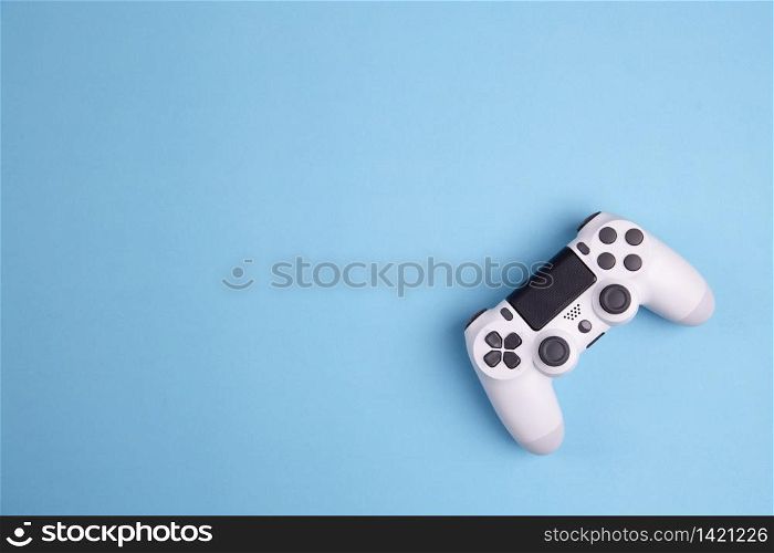 Joystick gaming controller isolated on blue background , Video game console developed Interactive Entertainment