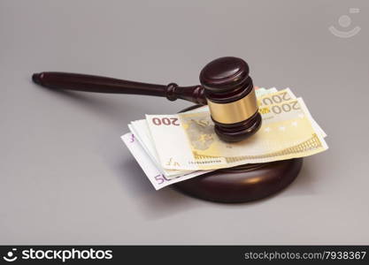 Judge gavel and euro banknotes isolated on gray