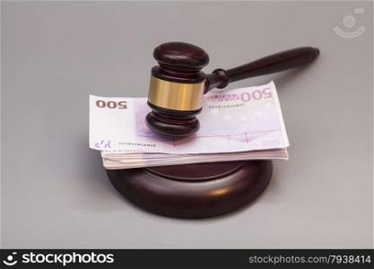 Judge gavel and euro banknotes isolated on gray