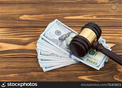 judge gavel and money on brown wooden table concept