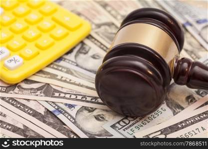 judge gavel,dollar banknotes and calculators
