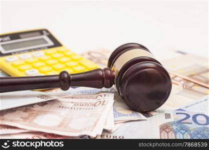 Judge gavel, euro banknotes and calculator