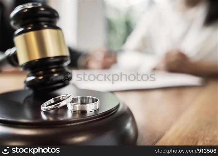Judge gavel with pair of marriage ring, Divorce concept.