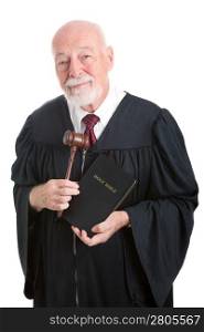 Judge holding his gavel and a bible. Metaphor for balancing church and state. Isolated on white.