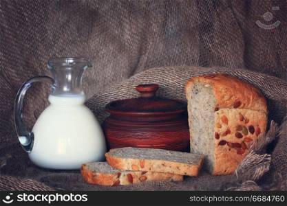 jug with milk and whole grain bread