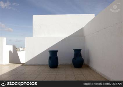 Jugs in front of a white wall
