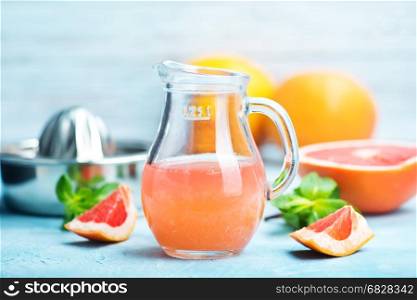 juice and fresh grapefruit on a table