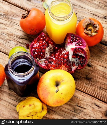 Juice from tropical fruits. Summer soft juice from fresh fruit. Drink from apples, pomegranate, persimmons and kiwi