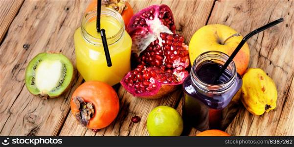 Juice from tropical fruits. Summer soft juice from fresh fruit. Drink from apples, pomegranate, persimmons and kiwi