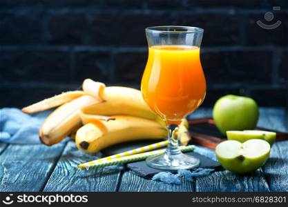 juice in glass from fresh banana and apples